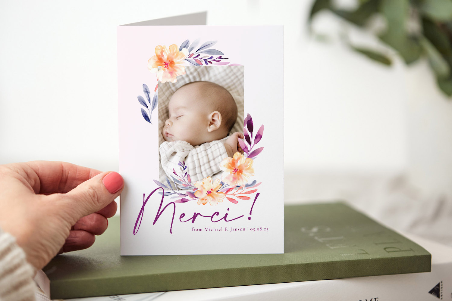 Baby thank you cards featuring a folded design with floral accents and a photo of a sleeping baby on the front cover.
