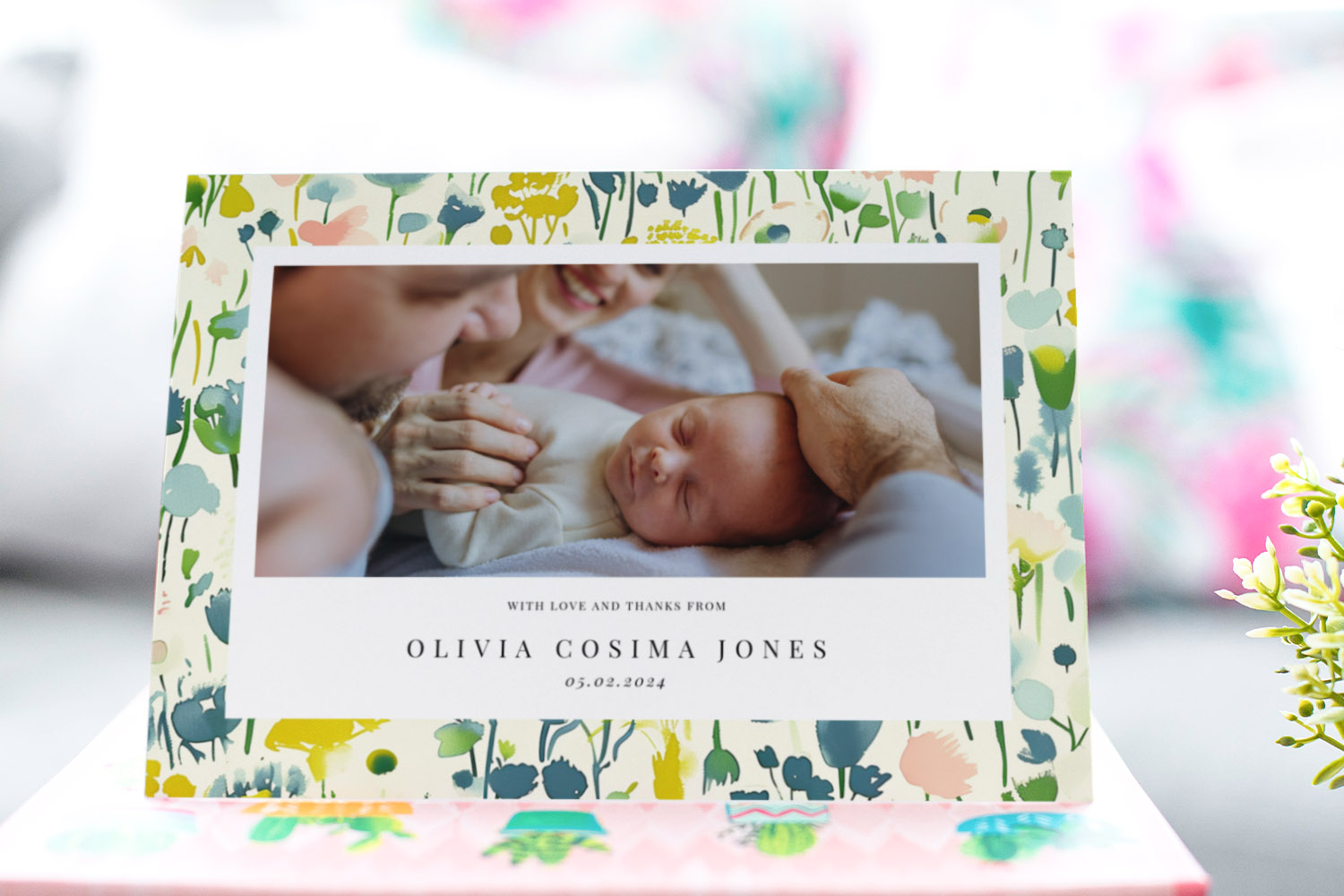 Baby thank you cards with floral border, featuring a newborn photo and personalised text on a soft pastel background.
