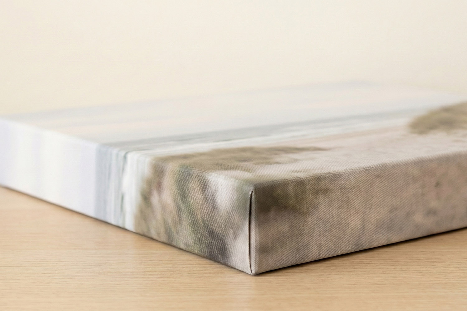 Canvas prints close-up showing wrapped edge detail and subtle landscape design on a wooden surface for home decor.