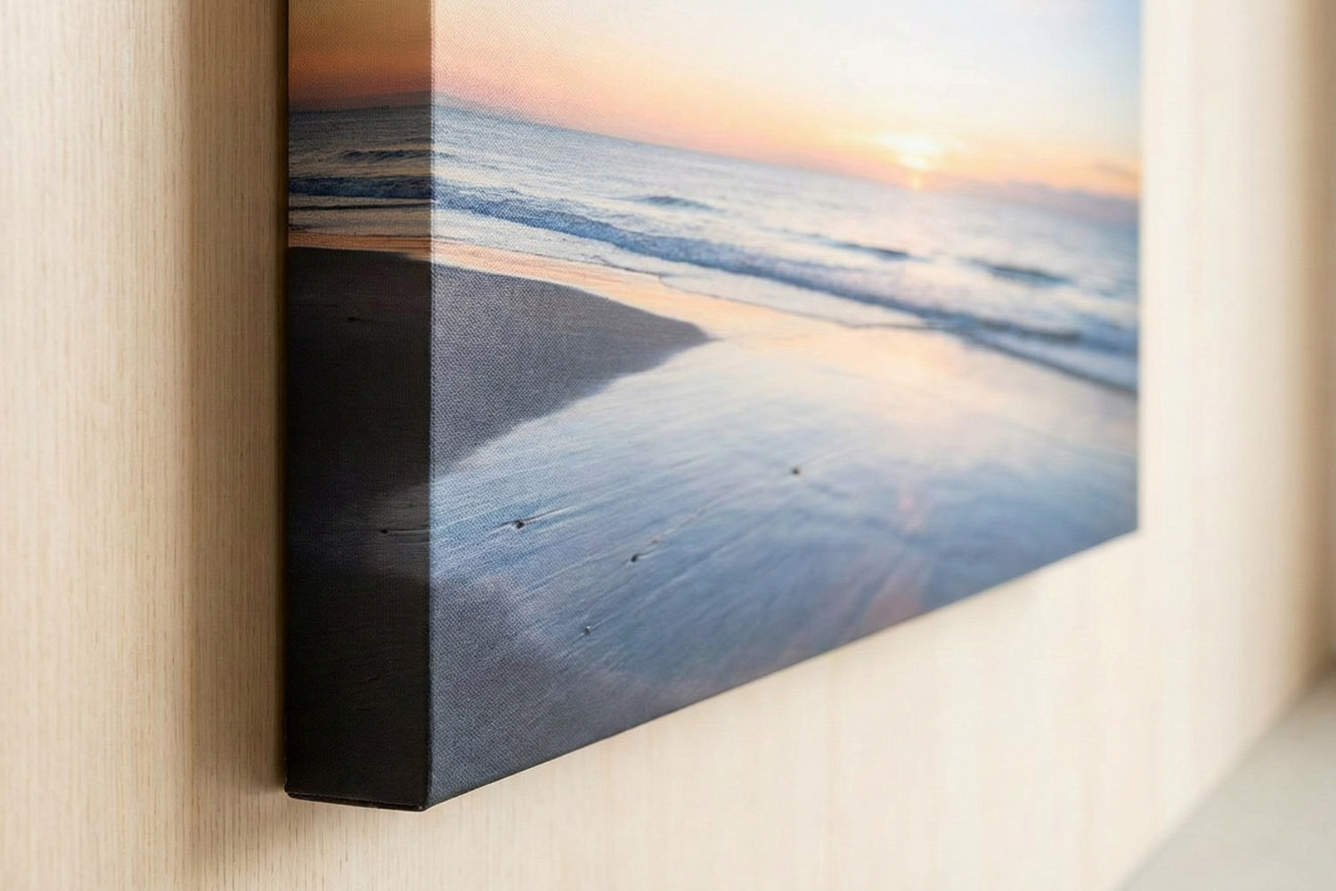 Canvas prints with a close-up of a seascape design, showing wrapped edges and textured surface on a light wall.