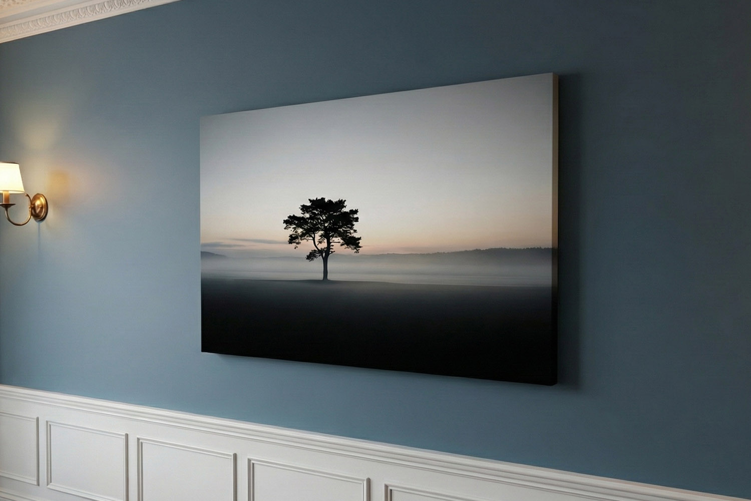 Canvas prints featuring a minimalist landscape with a lone tree at sunrise, mounted on a blue wall in a modern interior.
