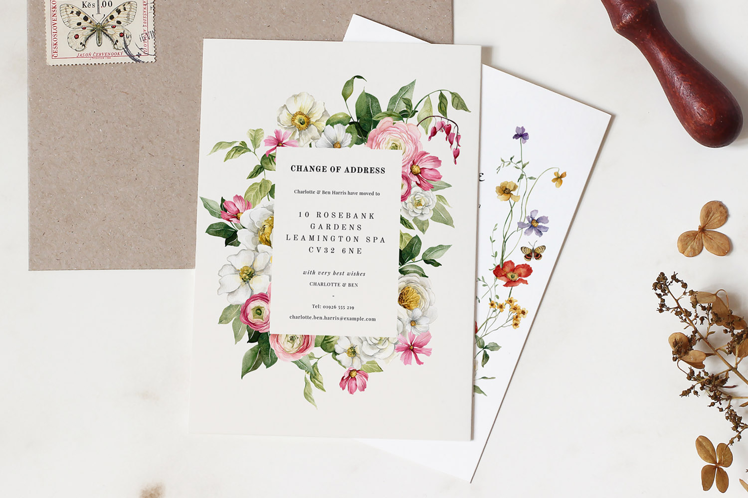 Change of address cards with elegant floral border design, featuring printed address details and botanical illustrations on