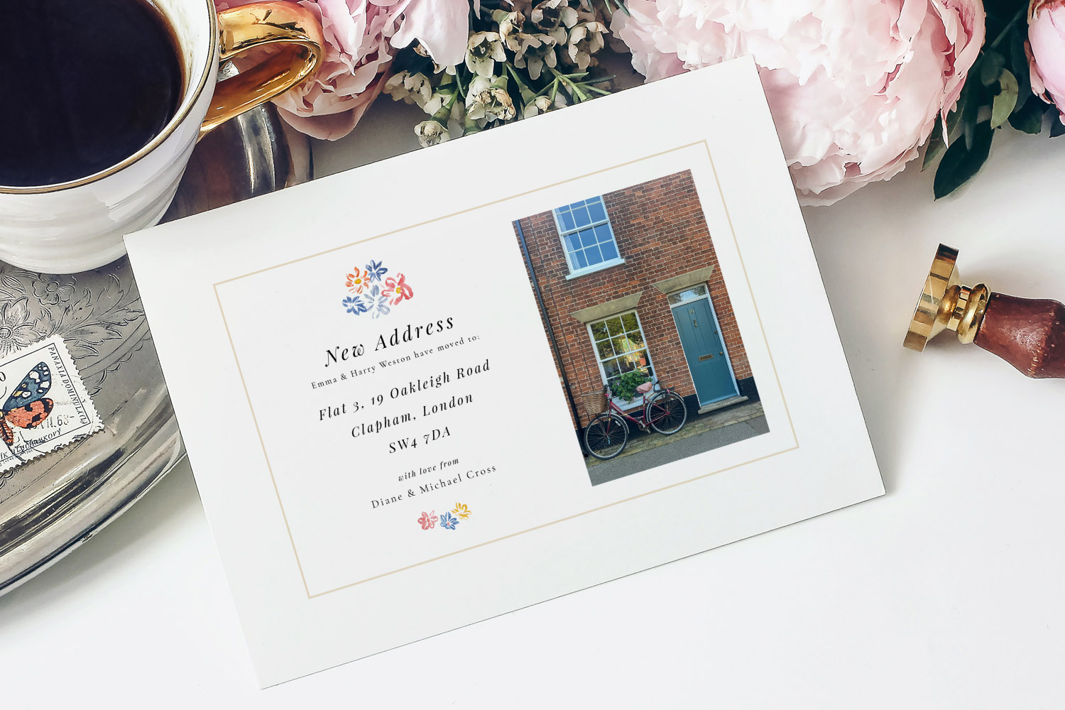 Change of Address Cards featuring a floral design, printed address details, and a house photo, displayed on a white surface