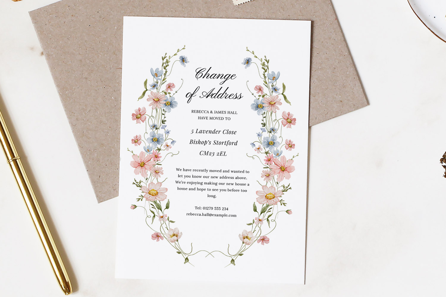 Change of Address Cards with pastel floral border, elegant script text and contact details, displayed on a white marble