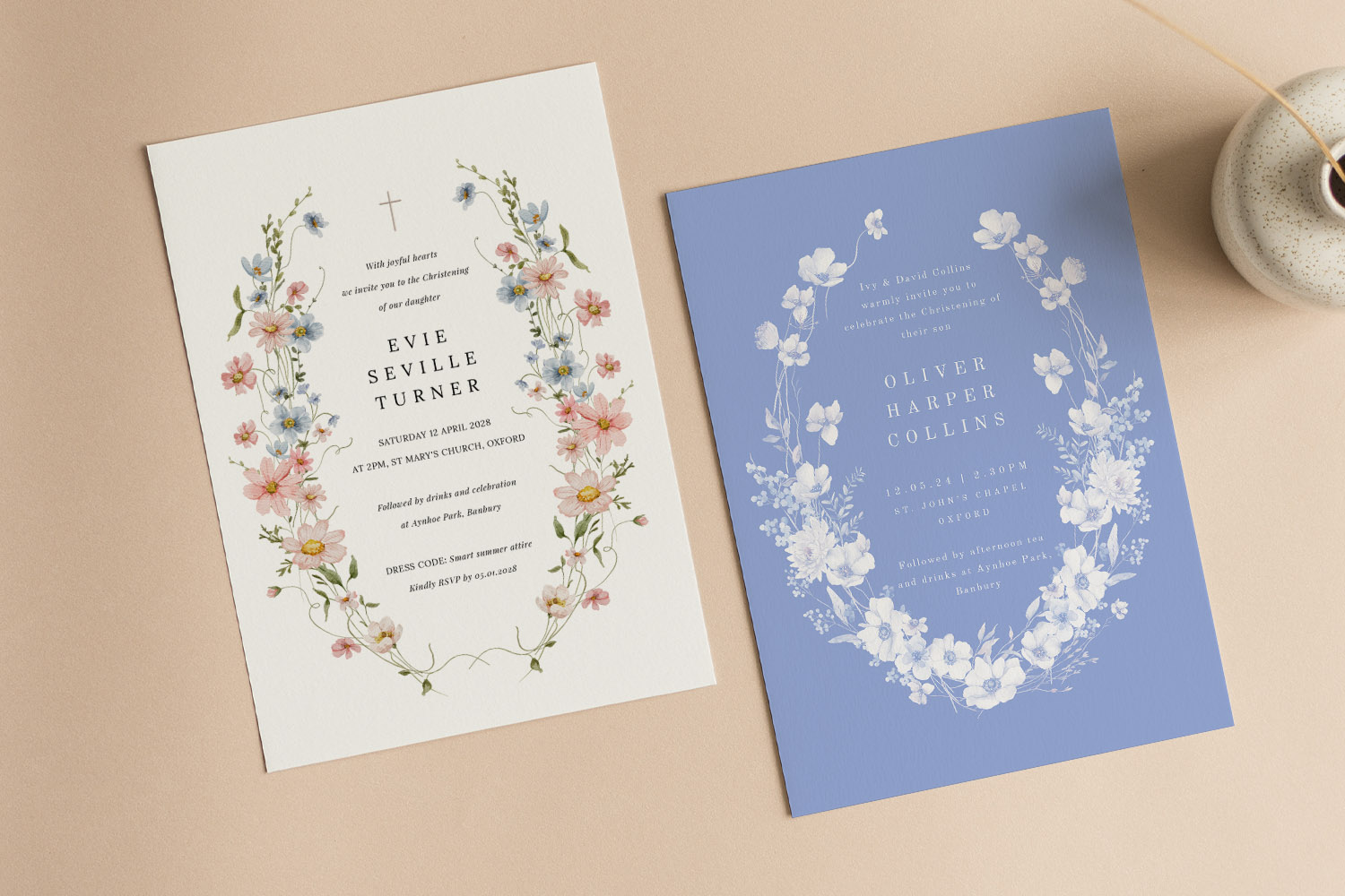 Christening invitations featuring floral designs, one with pastel flowers on white and one with white flowers on blue