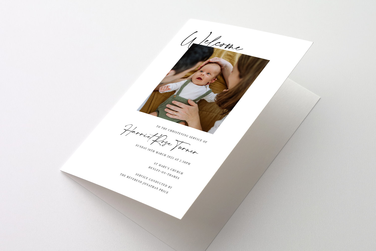 Christening Order of Service card with a personalised photo and elegant script text on a white folded cover, shown on a