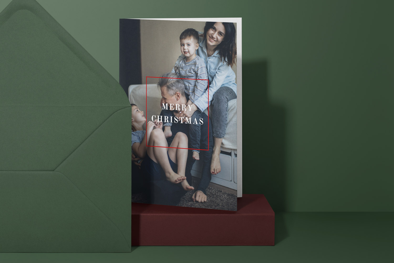 Christmas cards featuring a personalised family photo with Merry Christmas text, displayed with a green envelope on a green