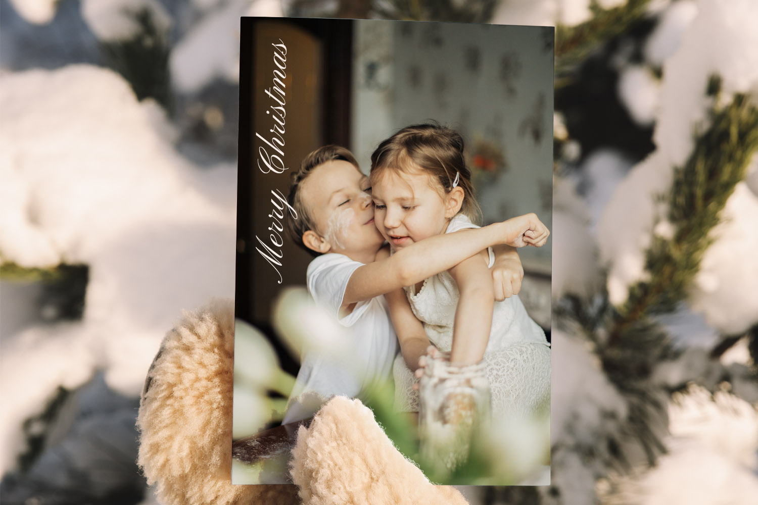 Christmas cards featuring a personalised photo of two children hugging, with Merry Christmas text in elegant script on the