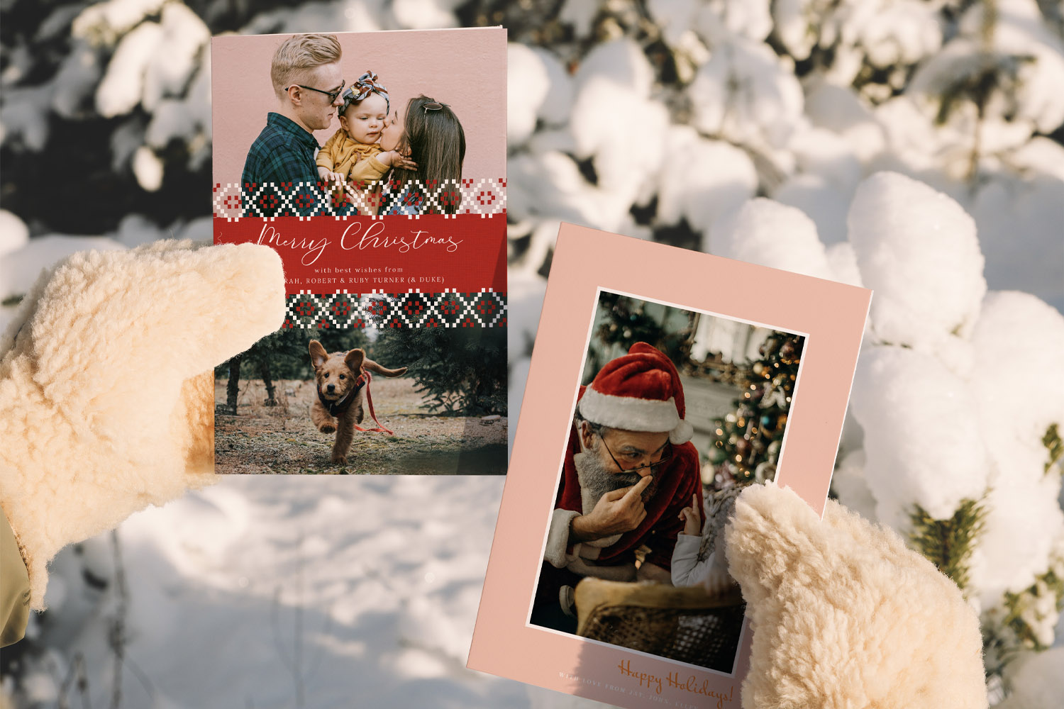 Christmas cards with family and Santa Claus designs held by gloved hands outdoors in a snowy winter setting