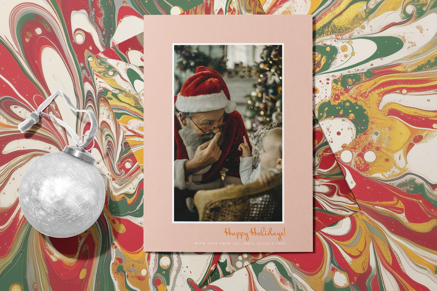 Christmas cards featuring a pink border and festive photo of Santa with a child, set on a marbled background with a silver