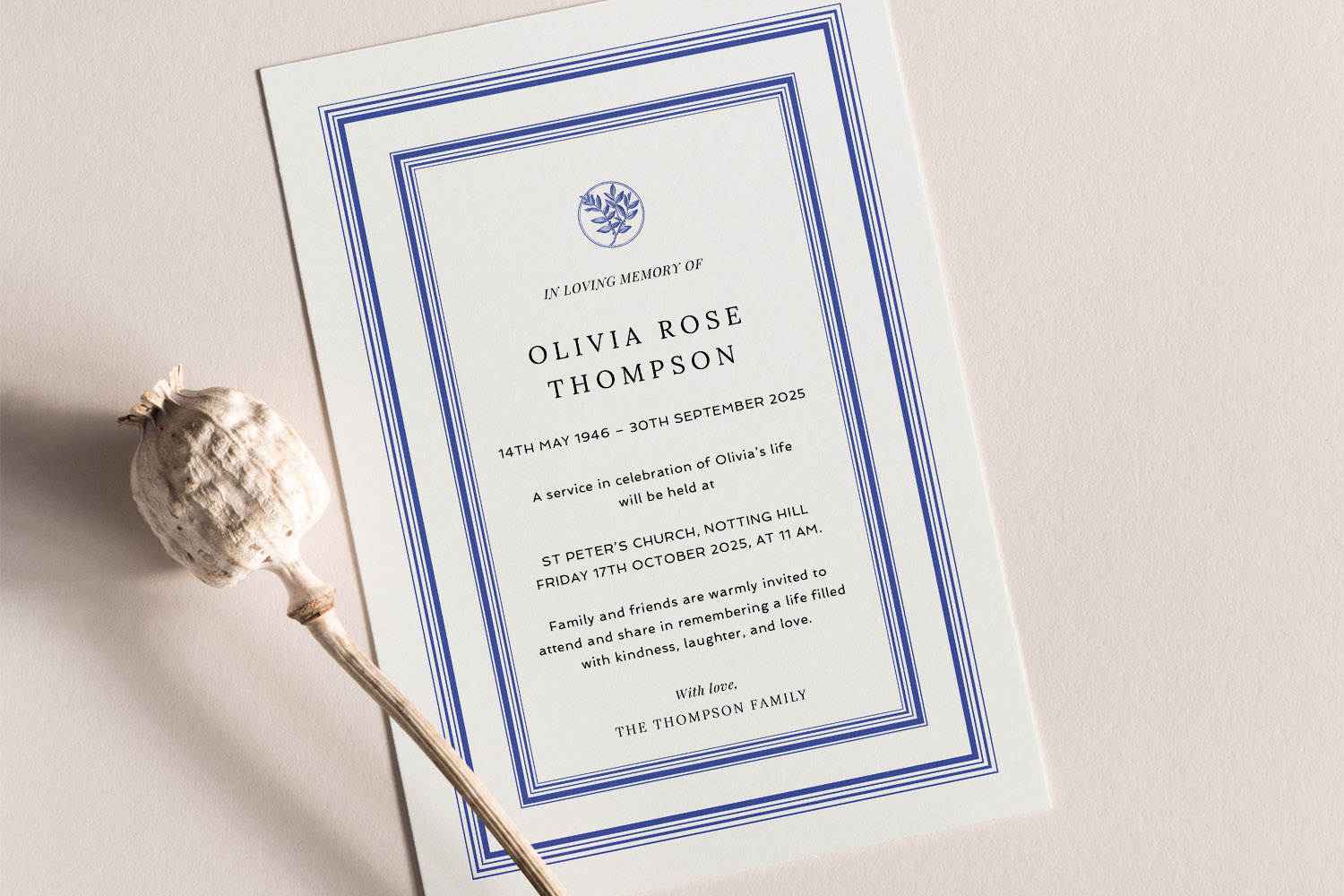 Funeral announcement card with blue border, elegant serif text and floral motif, displayed on a cream background with a