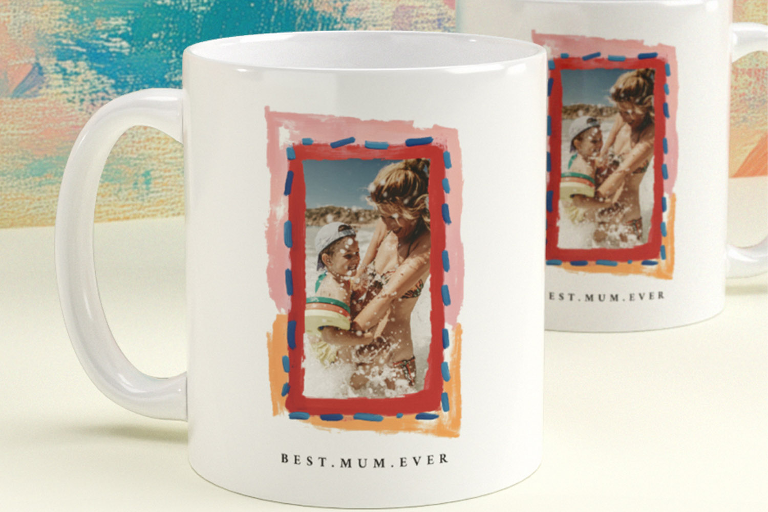 Personalised mugs with custom photo and Best Mum Ever text, featuring a colourful border on a white ceramic background.