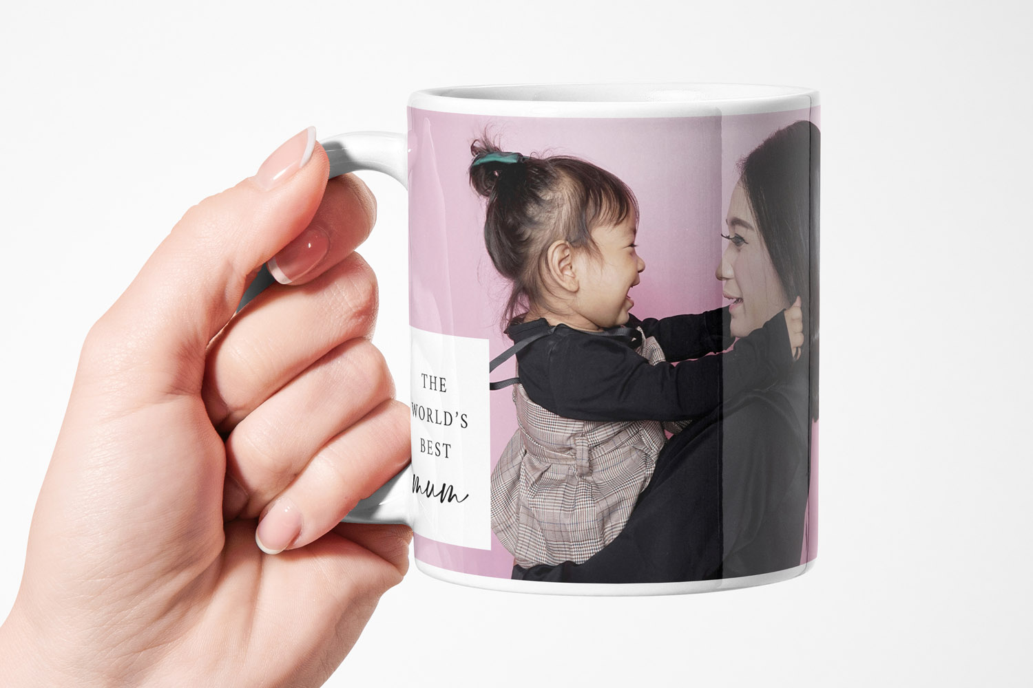 Personalised mug with custom photo and the text the world's best mum, held in a hand against a plain white background.