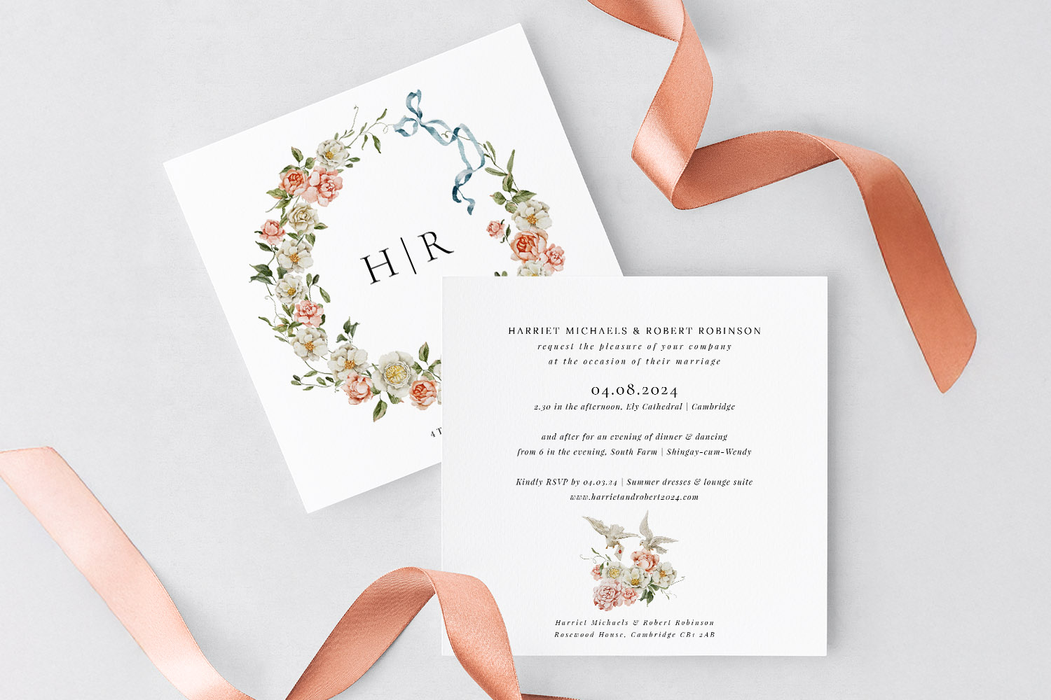 RSVP.studio wedding invitations with floral wreath design and elegant script, displayed with a peach satin ribbon on a