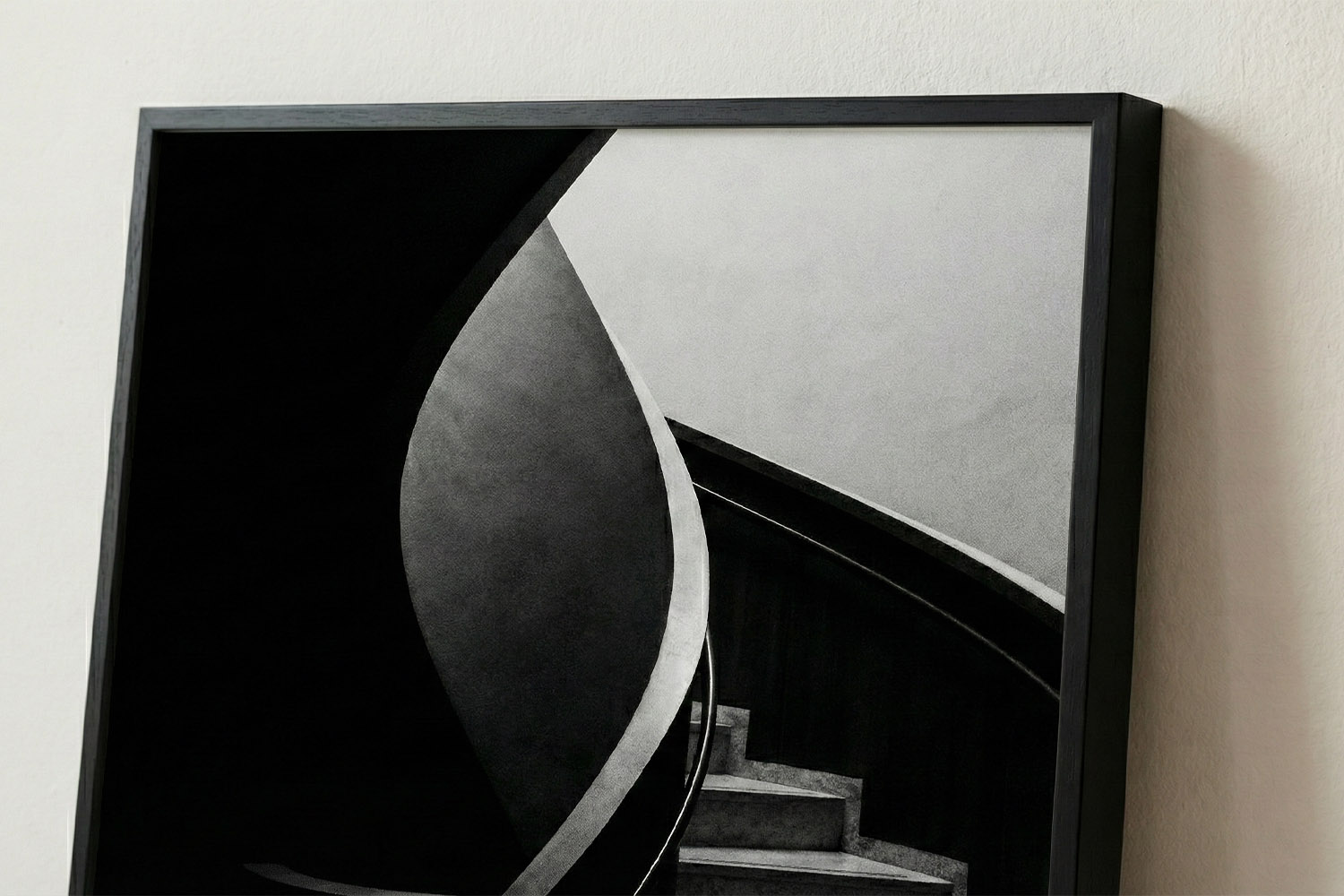 Simple framed prints featuring a monochrome abstract staircase design in a slim black frame, displayed on a light wall.