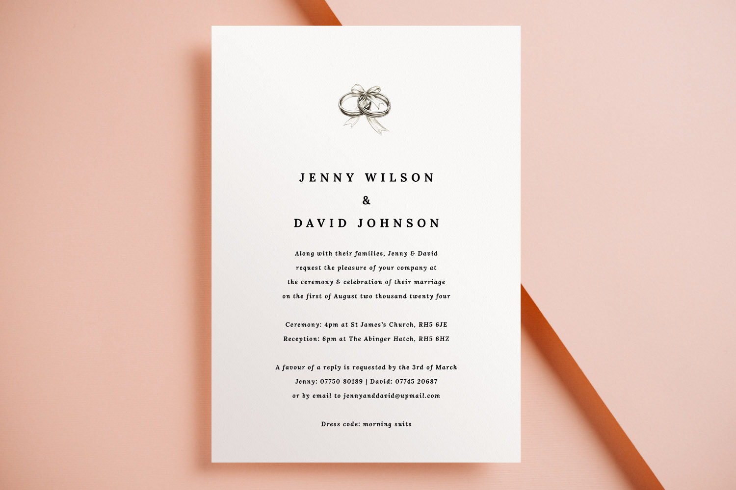 Wedding invitations featuring a minimalist white card with black text and a sketch of wedding rings, displayed on a peach