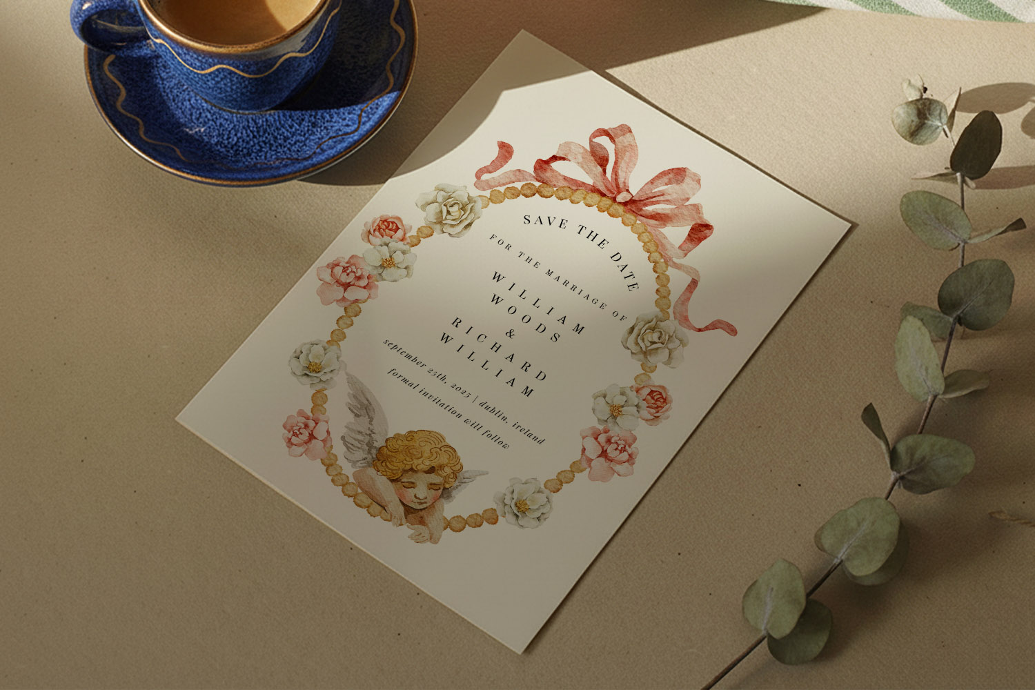 Wedding save the dates card with floral and cherub illustration, elegant script text, and a decorative ribbon border on a