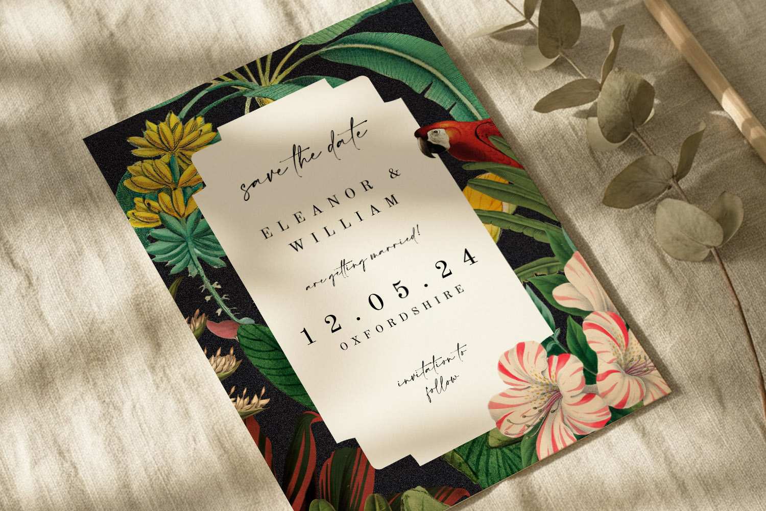 Wedding save the dates card with tropical floral and parrot design, elegant typography, and date details on textured paper.