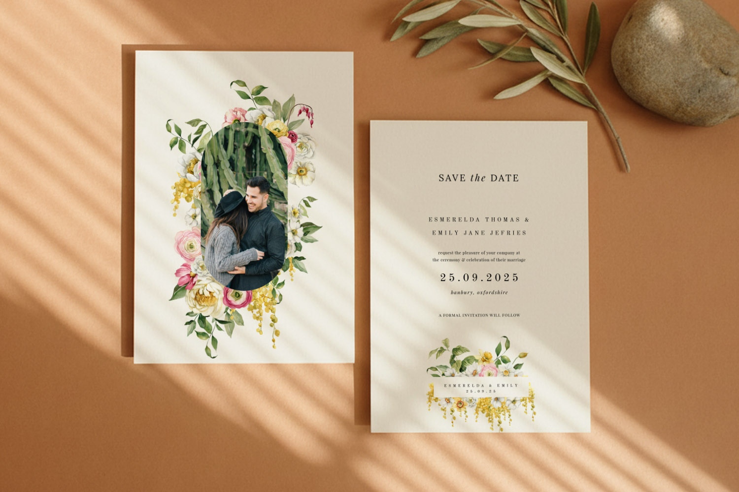 Wedding Save the Dates with floral border design, featuring a couple’s photo and elegant printed event details on cream card