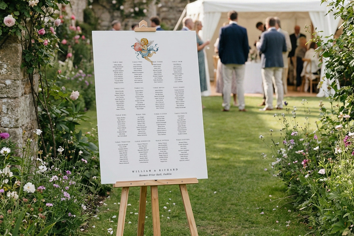 Wedding table plans displayed on a large white board with floral illustration, set on an easel in a garden venue setting