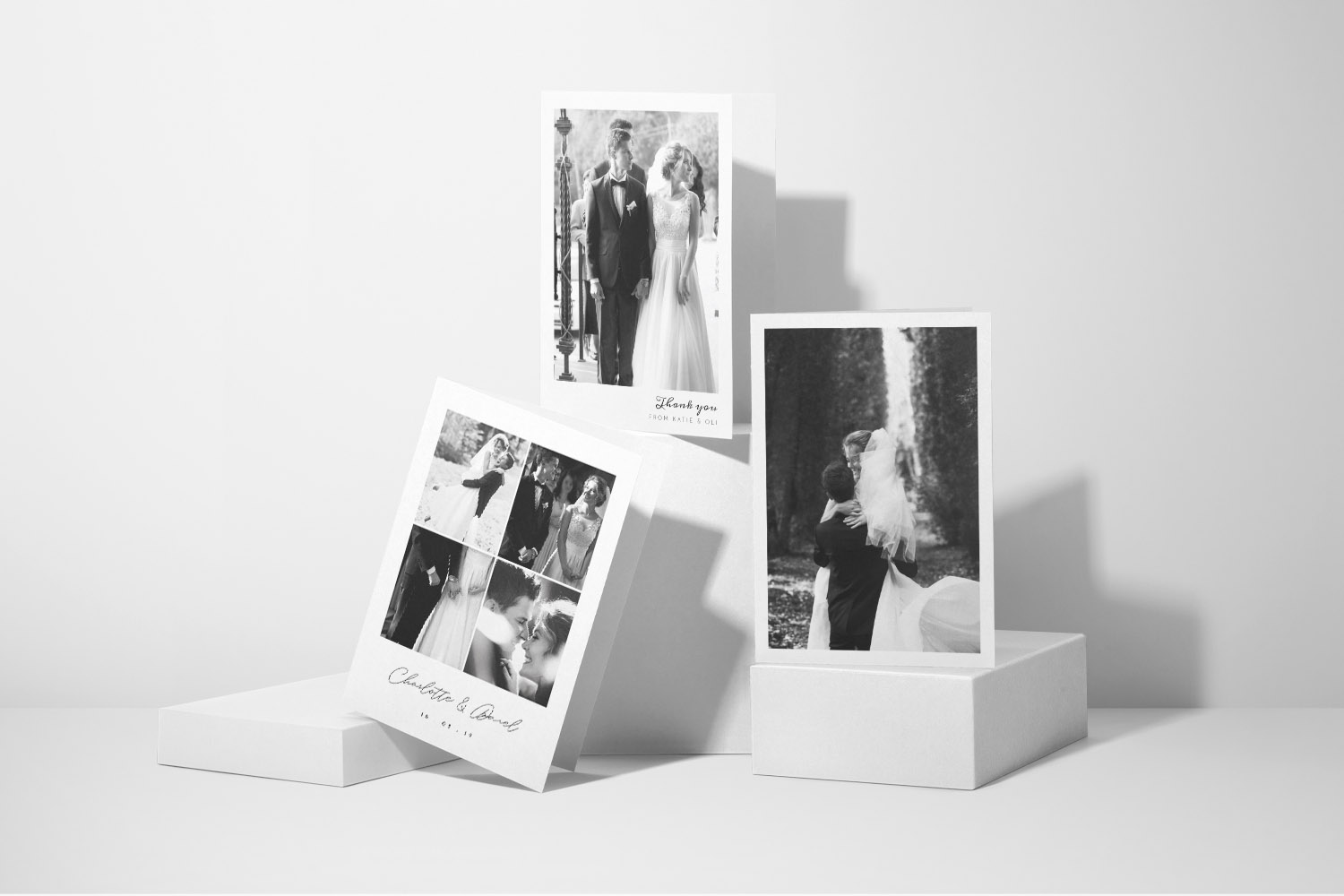 Wedding thank you cards featuring black and white photos of newlyweds in elegant, minimalist designs on white card stock.