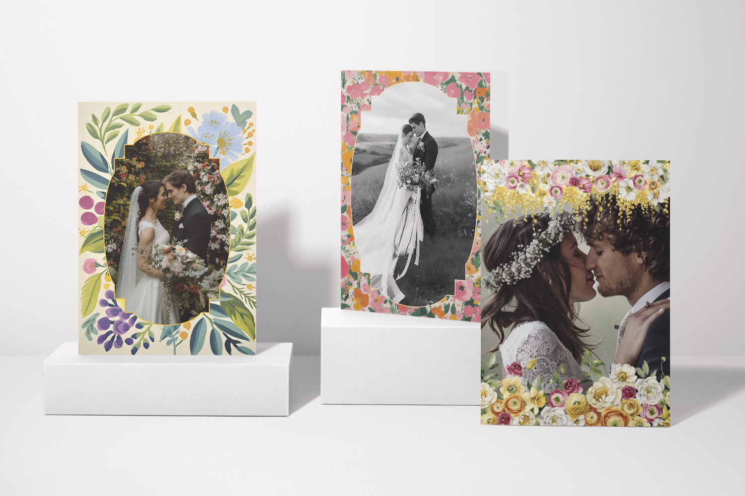 Wedding thank you cards with floral borders, each featuring a romantic couple’s portrait in a standing display arrangement.