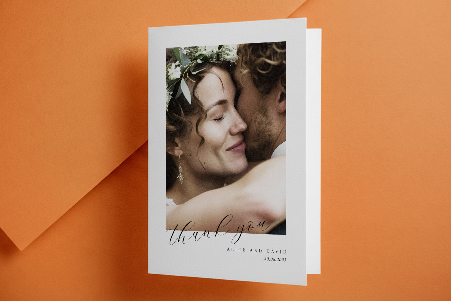 Wedding thank you cards featuring a couple embracing, with elegant script text and personalised names on a white folded card.