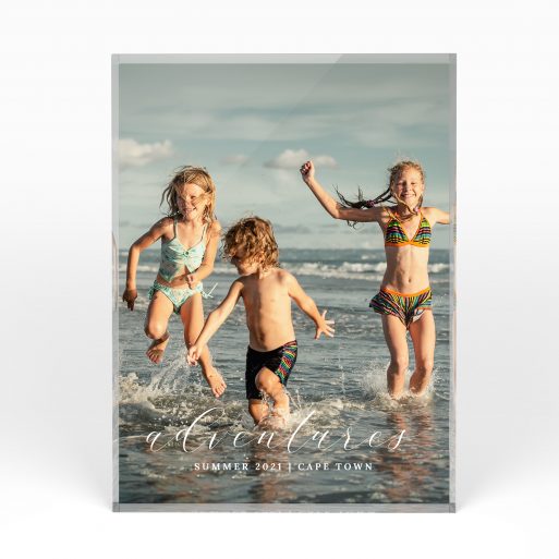 A front side view of a portrait layout Acrylic Glass Photo Block with space for 1 photo. Thiis design is named "Adventures". 