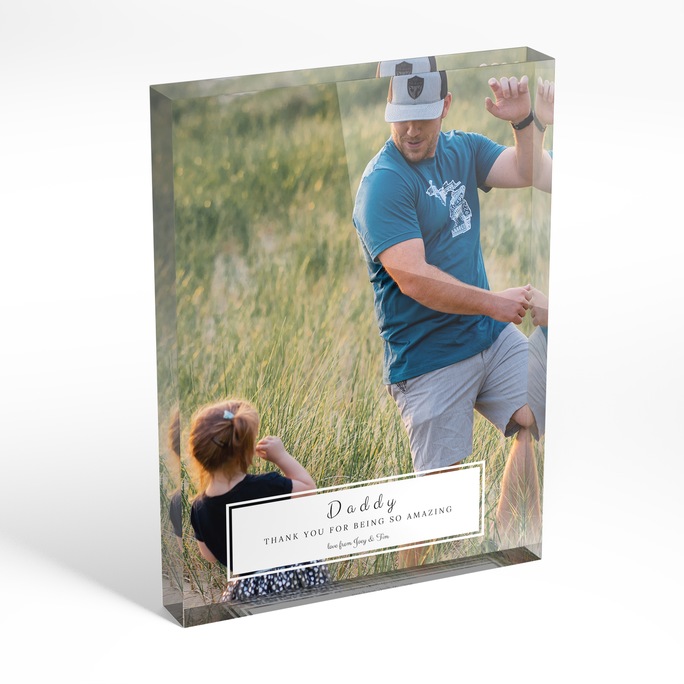 An angled side view of a portrait layout Acrylic Glass Photo Block with space for 1 photo. Thiis design is named "Paternal Bottom Frame". 