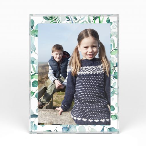 A front side view of a portrait layout Acrylic Photo Block with space for 1 photo. Thiis design is named "Floral Photo Frame". 