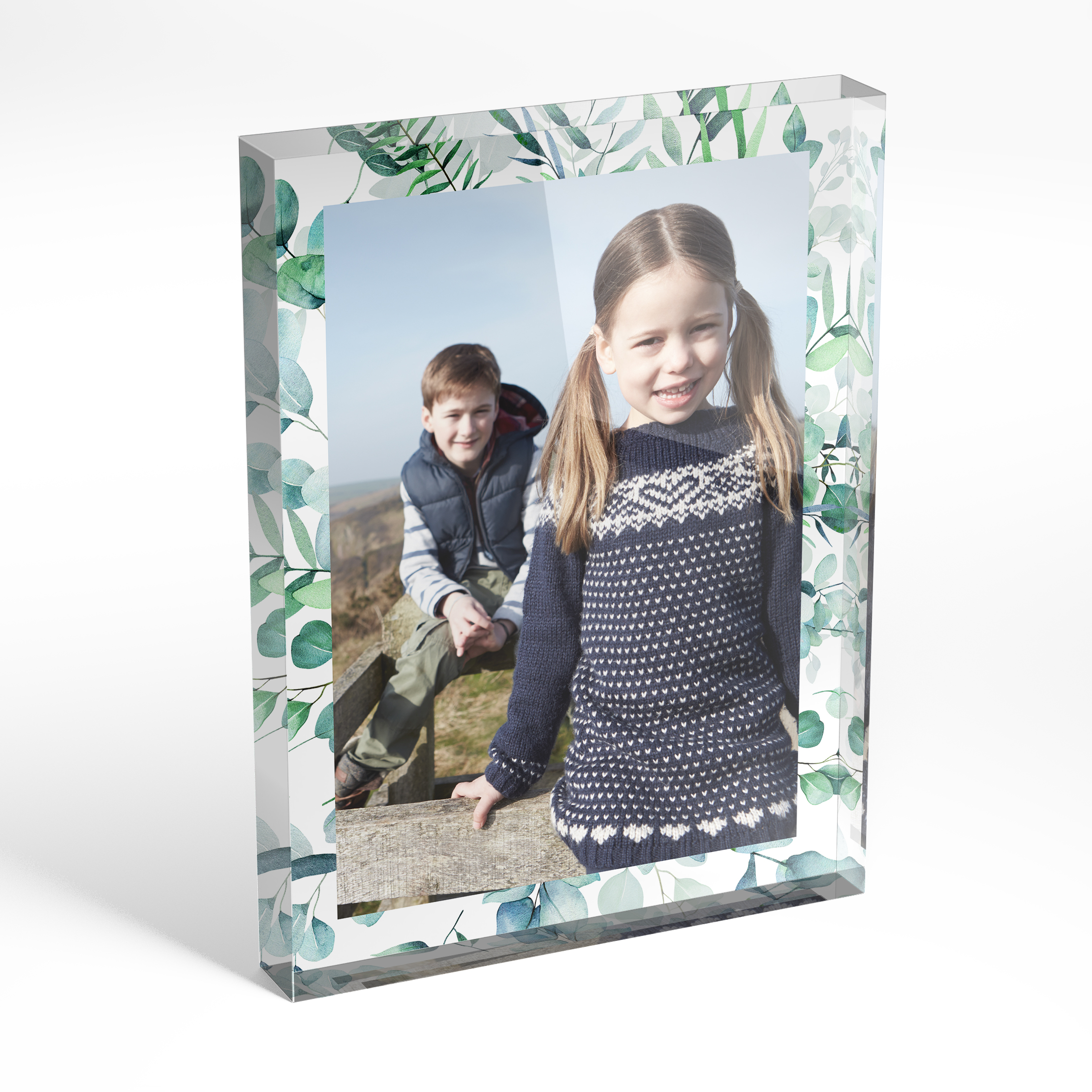 An angled side view of a portrait layout Acrylic Photo Block with space for 1 photo. Thiis design is named "Floral Photo Frame". 