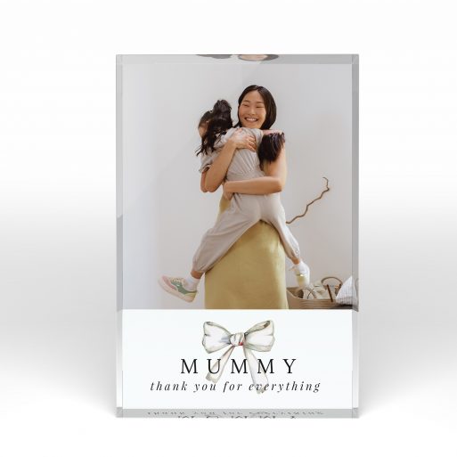 A front side view of a portrait layout Online acrylic photo blocks with space for 1 photo. Thiis design is named "Tied with a bow". 