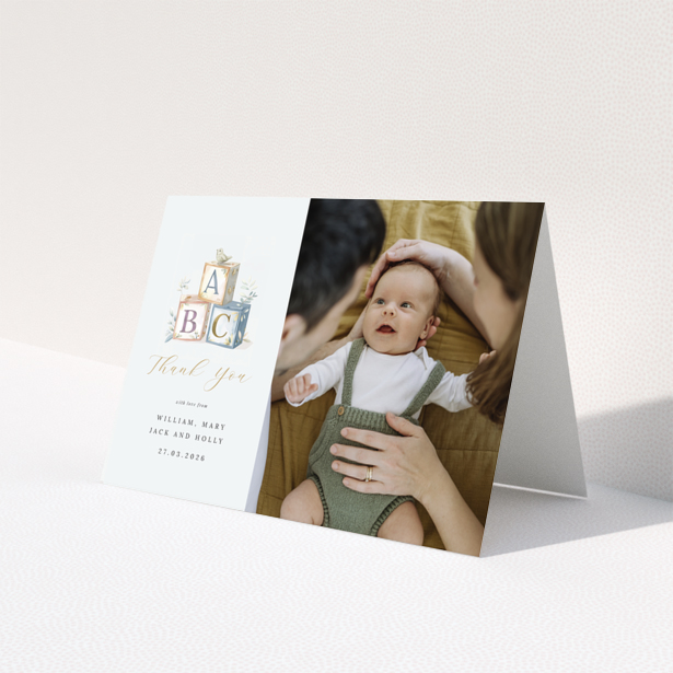 Baby thank you card with illustration of alphabet blocks and one photo of a baby with parents.