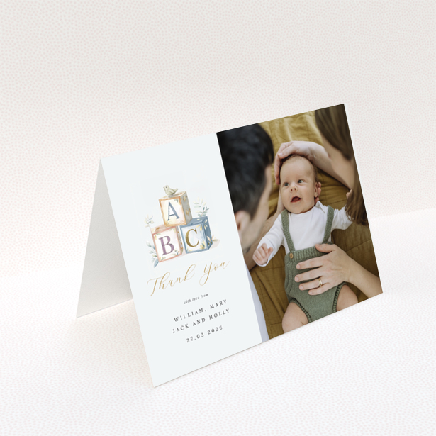 Baby thank you card with illustration of alphabet blocks and one photo of a baby with parents.