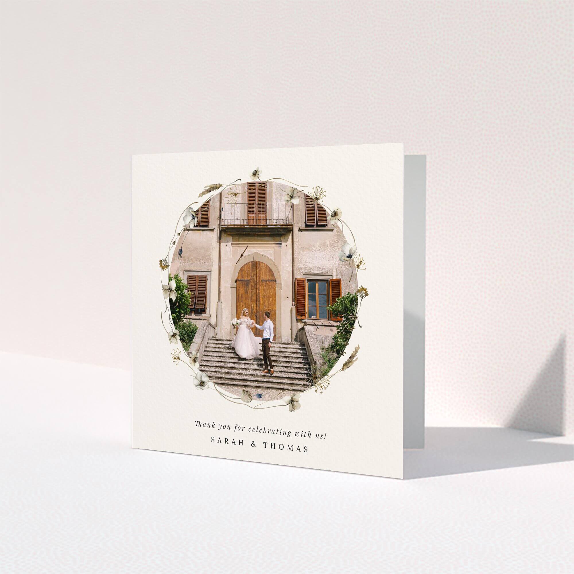 Elegant wedding thank you card with floral border and one photo of a couple on steps.