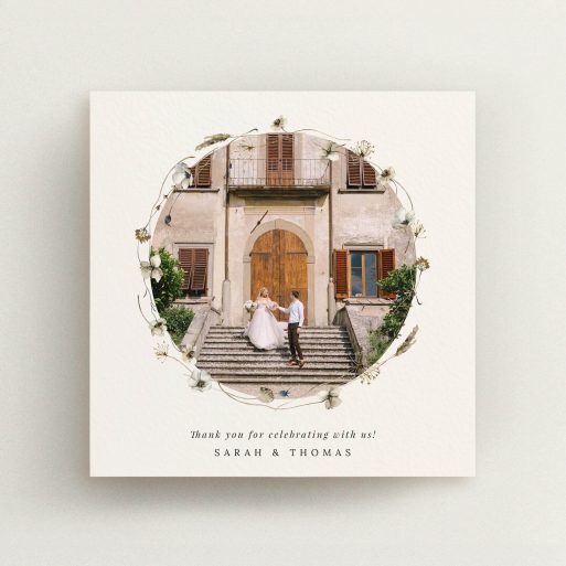 Elegant wedding thank you card with floral border and one photo of a couple on steps.