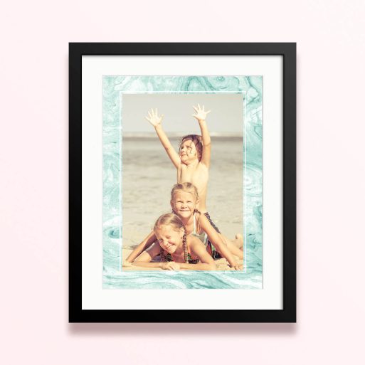 Framed and mounted photo print featuring three children on a beach.