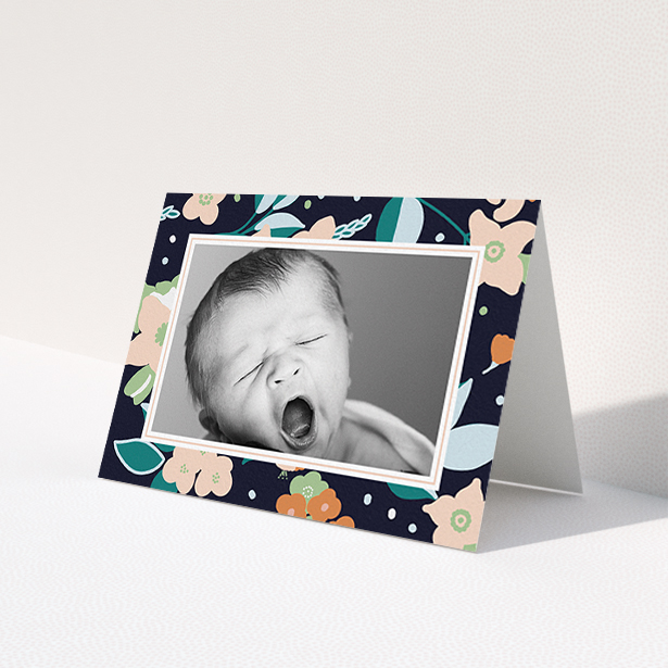 A baby card design titled "Bedtime Garden". It is an A6 card in a landscape orientation. It is a photographic baby card with room for 1 photo. "Bedtime Garden" is available as a folded card, with tones of navy blue, pink and orange.