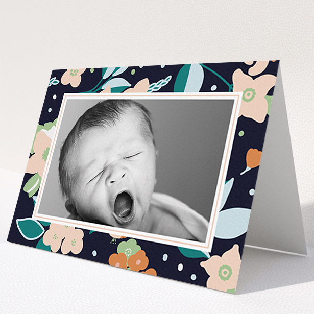 A baby card design titled "Bedtime Garden". It is an A6 card in a landscape orientation. It is a photographic baby card with room for 1 photo. "Bedtime Garden" is available as a folded card, with tones of navy blue, pink and orange.