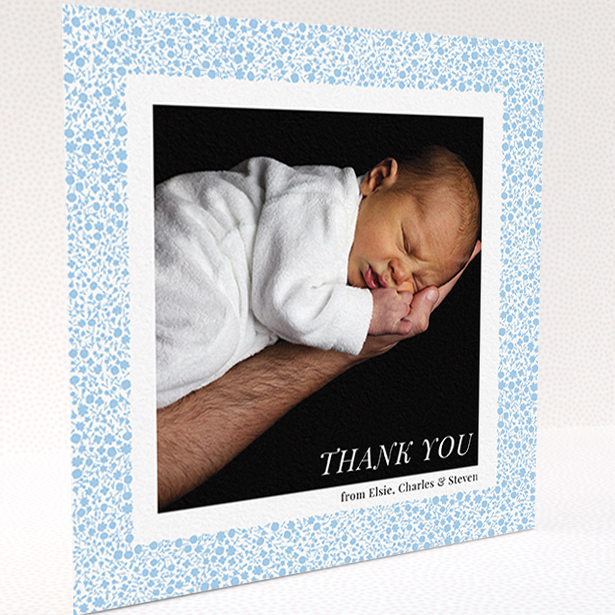 A baby card named "Blue Floral Frame". It is a square (148mm x 148mm) card in a square orientation. It is a photographic baby card with room for 1 photo. "Blue Floral Frame" is available as a folded card, with tones of blue and white.