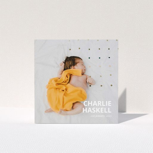 A baby card design named "Bold Photo Corner". It is a square (148mm x 148mm) card in a square orientation. It is a photographic baby card with room for 1 photo. "Bold Photo Corner" is available as a folded card, with mainly white colouring.