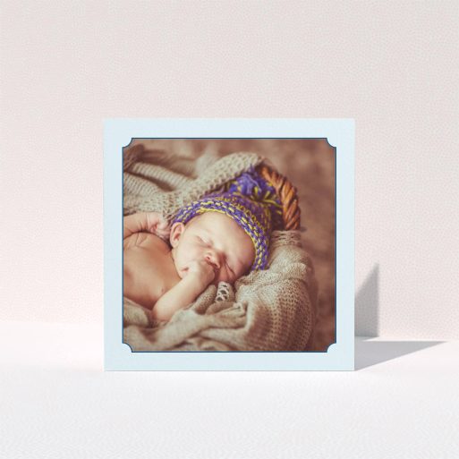 A baby card named "Classic Frame". It is a square (148mm x 148mm) card in a square orientation. It is a photographic baby card with room for 1 photo. "Classic Frame" is available as a folded card, with mainly blue colouring.
