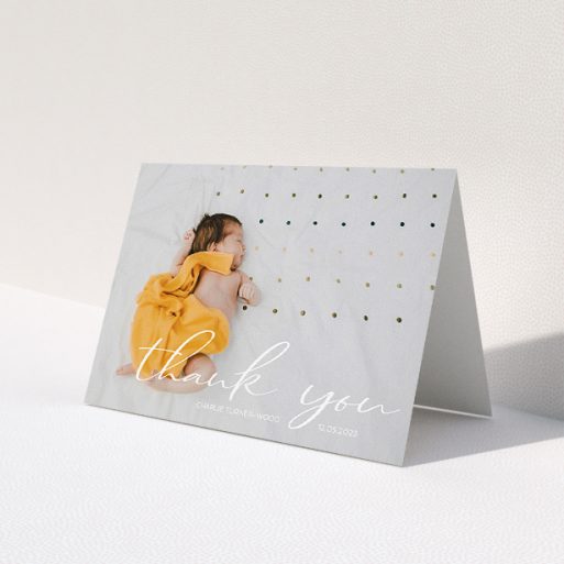 A baby card called 'Handwritten Thanks'. It is an A5 card in a landscape orientation. It is a photographic baby card with room for 1 photo. 'Handwritten Thanks' is available as a folded card, with mainly white colouring.