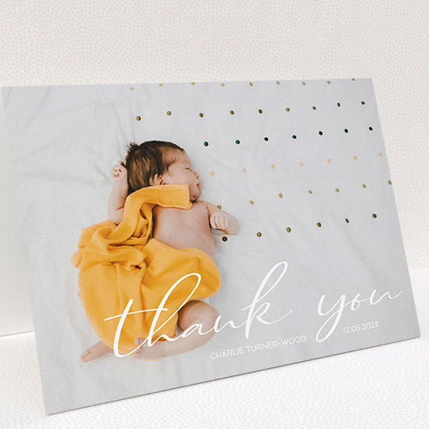 A baby card called "Handwritten Thanks". It is an A5 card in a landscape orientation. It is a photographic baby card with room for 1 photo. "Handwritten Thanks" is available as a folded card, with mainly white colouring.
