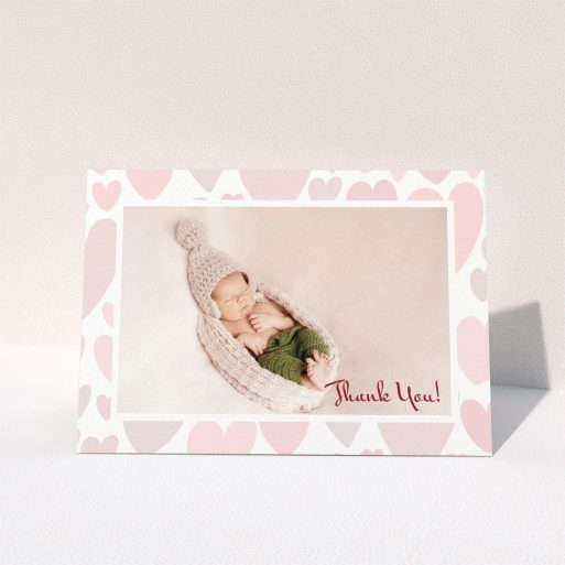 A baby card template titled "Pastel Hearts". It is an A6 card in a landscape orientation. It is a photographic baby card with room for 1 photo. "Pastel Hearts" is available as a folded card, with tones of pink and white.