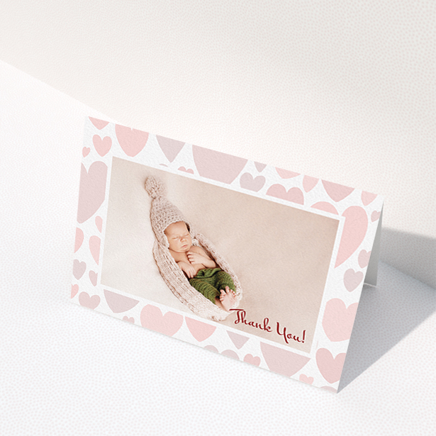 A baby card template titled "Pastel Hearts". It is an A6 card in a landscape orientation. It is a photographic baby card with room for 1 photo. "Pastel Hearts" is available as a folded card, with tones of pink and white.