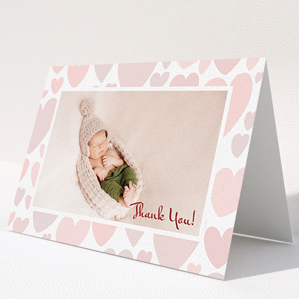 A baby card template titled "Pastel Hearts". It is an A6 card in a landscape orientation. It is a photographic baby card with room for 1 photo. "Pastel Hearts" is available as a folded card, with tones of pink and white.