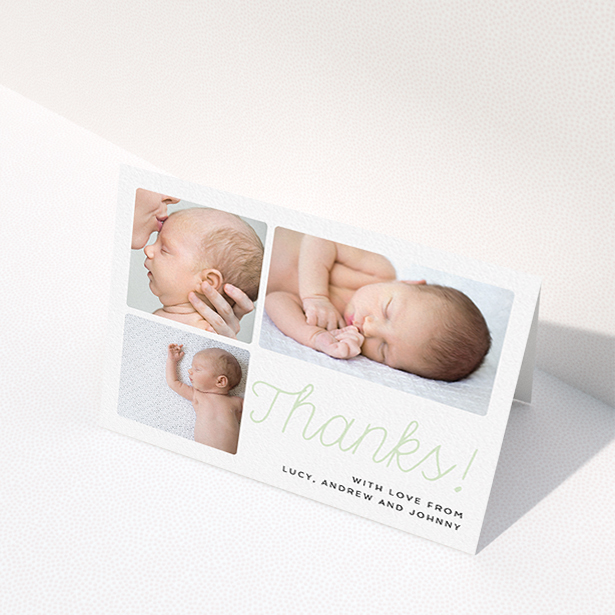 A baby card design named "Thank You Cursive". It is an A6 card in a landscape orientation. It is a photographic baby card with room for 3 photos. "Thank You Cursive" is available as a folded card, with tones of white and green.