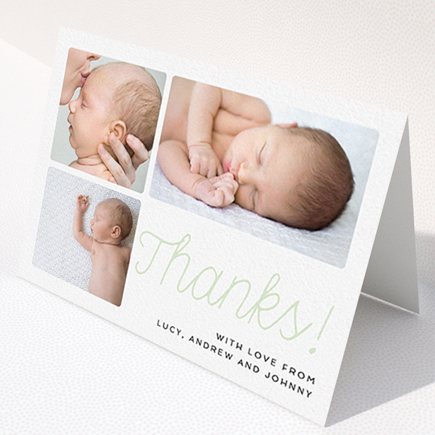 A baby card design named "Thank You Cursive". It is an A6 card in a landscape orientation. It is a photographic baby card with room for 3 photos. "Thank You Cursive" is available as a folded card, with tones of white and green.