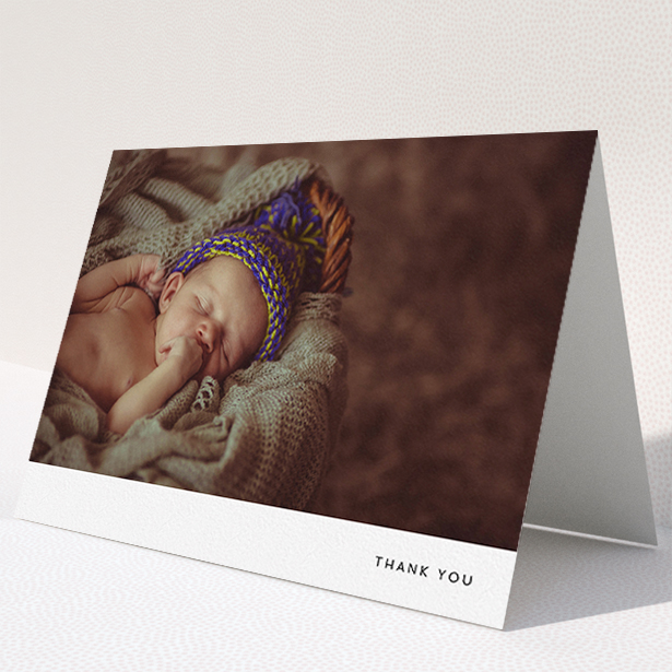 A baby card design titled "Thankful with Simplicity". It is an A5 card in a landscape orientation. It is a photographic baby card with room for 1 photo. "Thankful with Simplicity" is available as a folded card, with mainly white colouring.